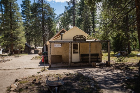 The camp office and its front porch, with the morning sun in the trees.
