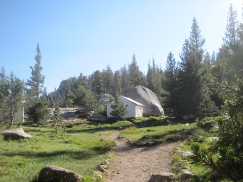 A guest tent tucked against a glacial boulder on the granite bench.