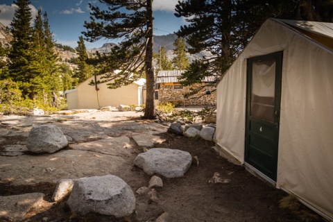 A tent cabin doorstep and the granite boulders that furnish the front yard.