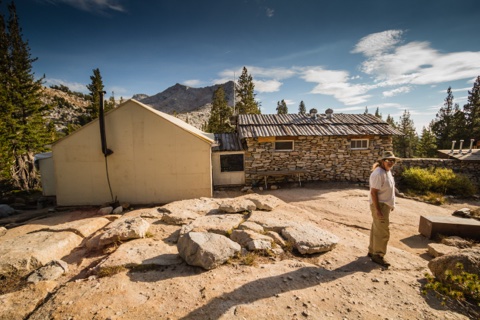 The stone dining hall and white kitchen wing on the granite bench.
