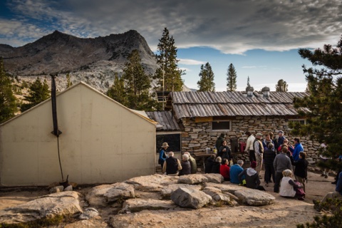 Hikers gathered outside the stone kitchen at Vogelsang High Sierra Camp