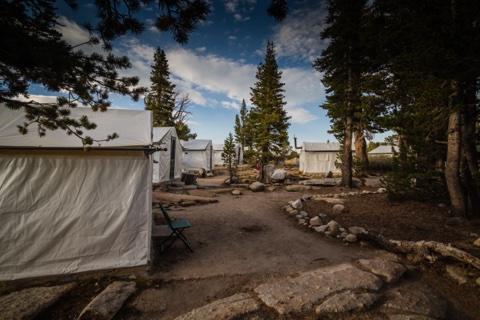 The stone-lined path winding between guest tent cabins.