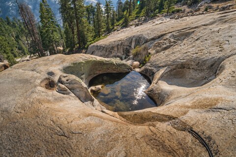 One of Gary's Pools — a water-carved pothole in the bare granite between Vogelsang and Merced Lake, catching the afternoon sun. Lightly restored.